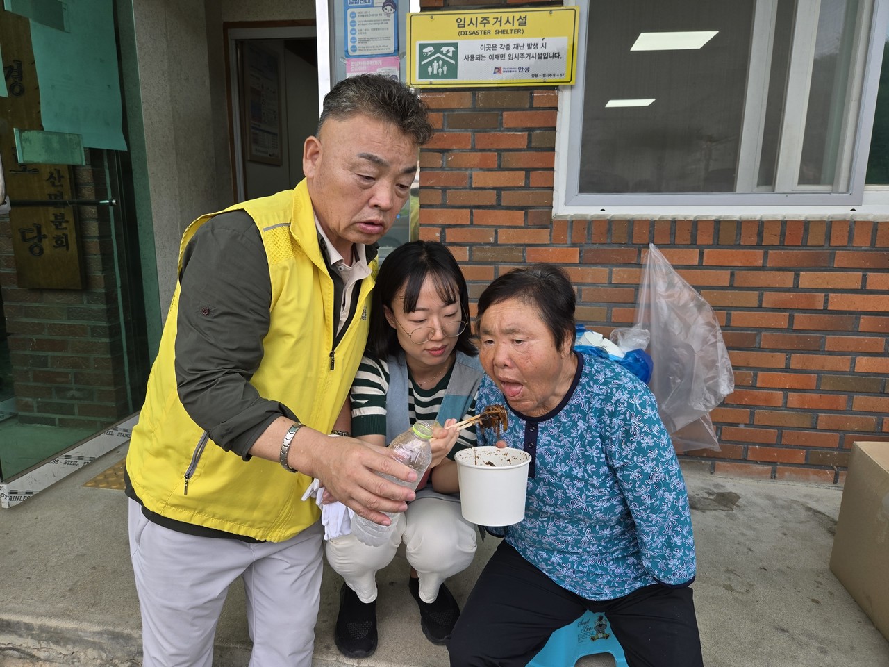                        ▲몸이 불편한 어르신의 식사 시중을 들고 있는  이진석 운영위원장
