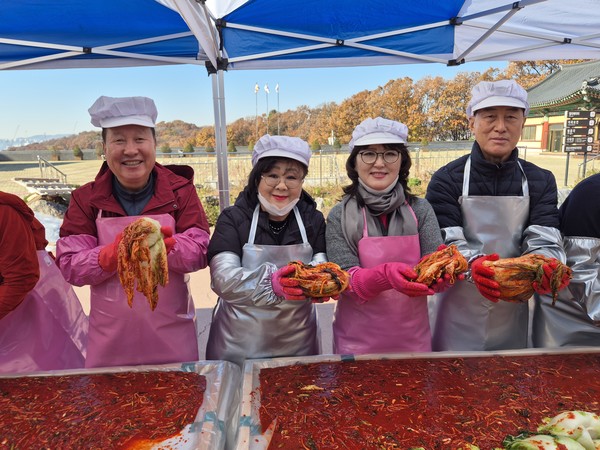대광사 김장나눔행사에 참석한 시도의원이 김장김치를 들어보이고있다